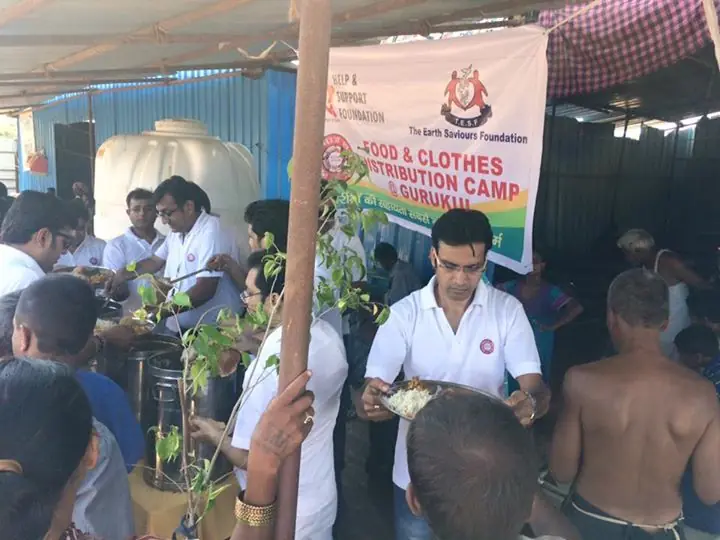 Volunteers serving food at a camp